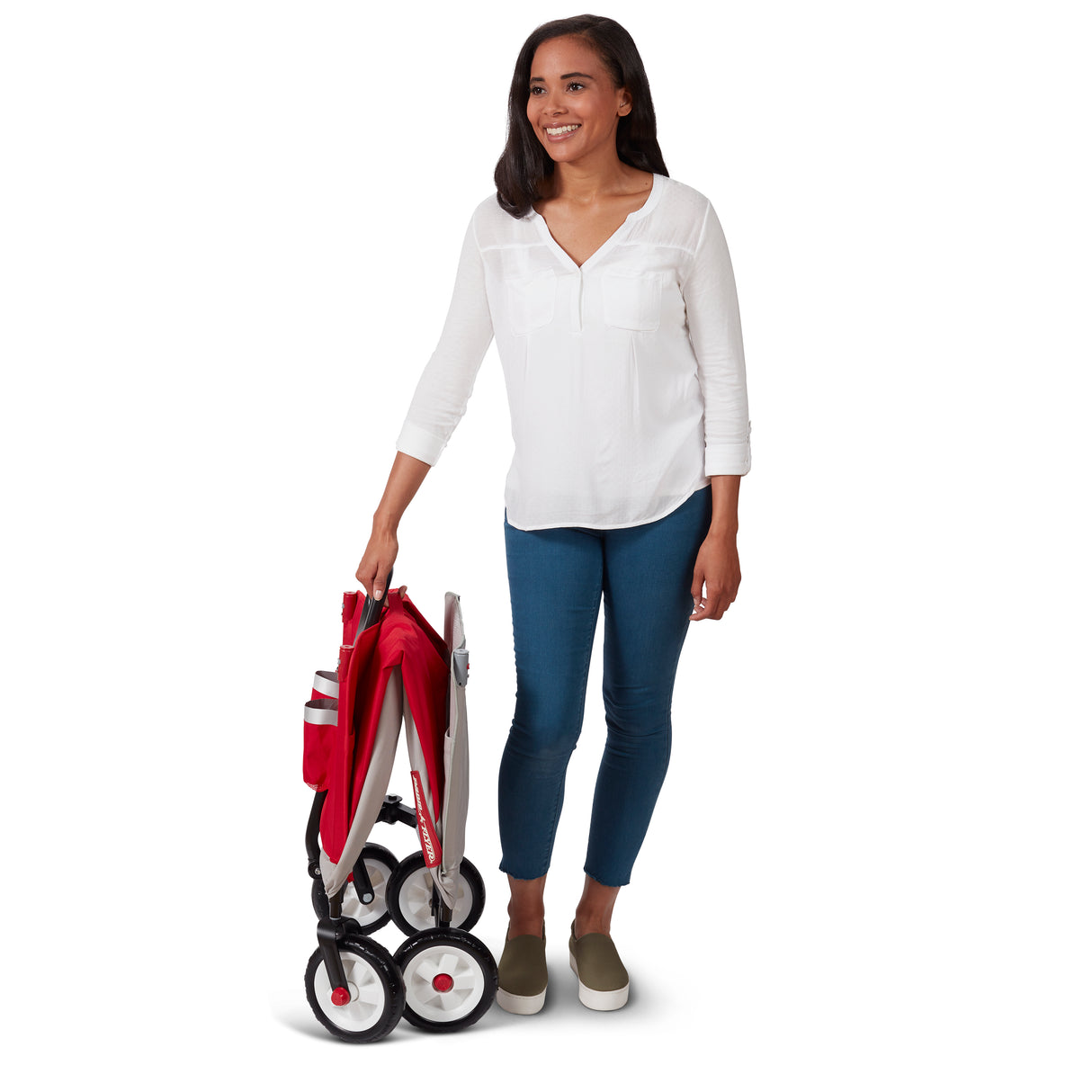 Woman holding a folded red and gray wagon on a white background