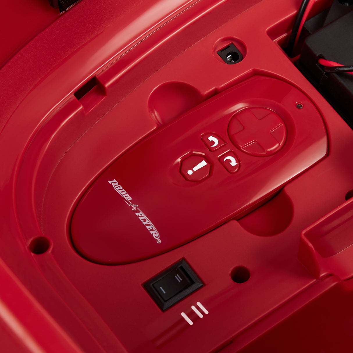 Parent remote stored securely in the built-in compartment beneath the seat for convenient access