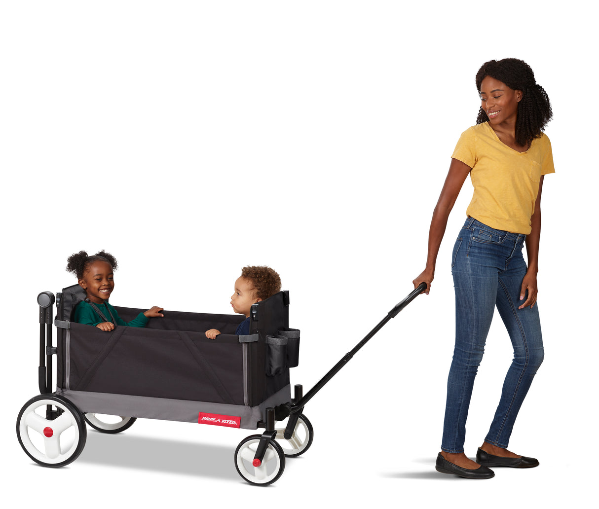 Mom pulling the black folding wagon with two toddlers riding in it