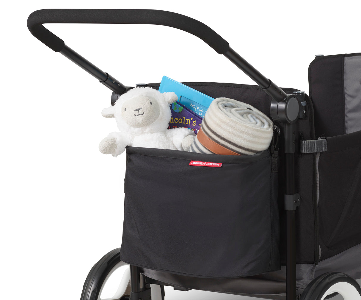 Rear storage bag on a wagon filled with a blanket, stuffed animal, and book