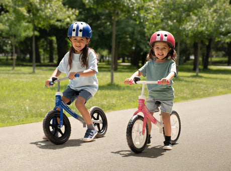 Two kids riding Radio Flyer balance bikes
