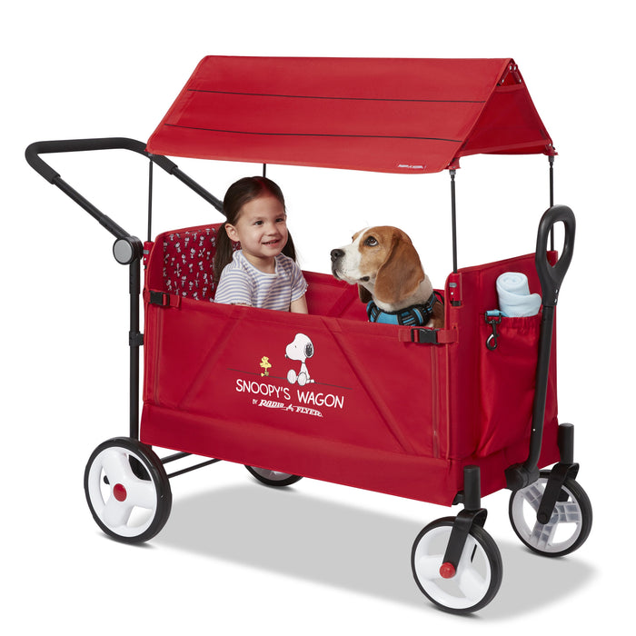 child and dog sitting in dog wagon