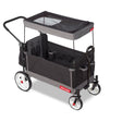 Black folding wagon with a canopy and rear storage bag. The canopy has a peek-a-boo window