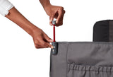 Person adjusting the canopy pole on the gray folding wagon with a white background