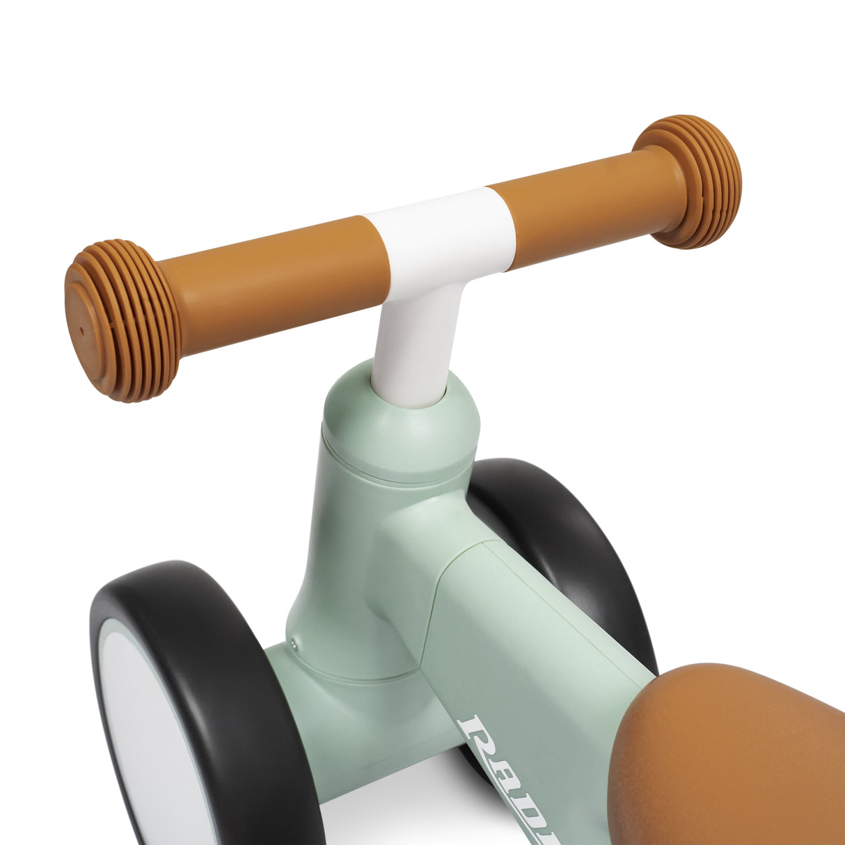 Close-up of a children's balance bike handlebar and frame, featuring a mint green body, brown grips and black wheels on a white background.