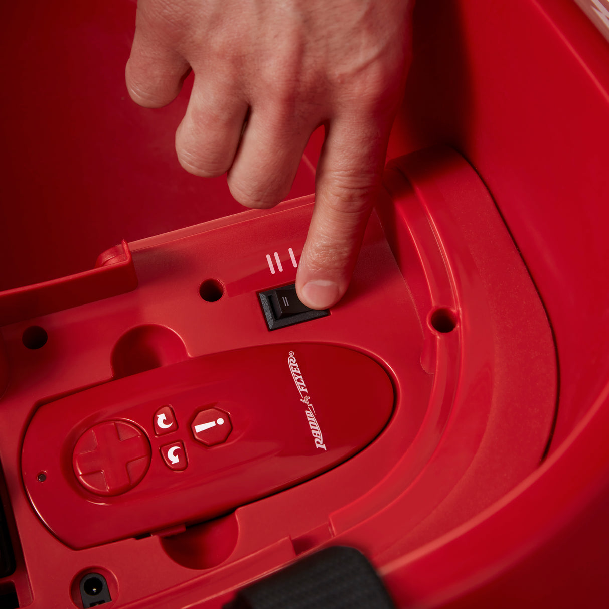 Close-up of the two-speed selector switch inside the ride-on car, allowing parents to choose the appropriate driving speed