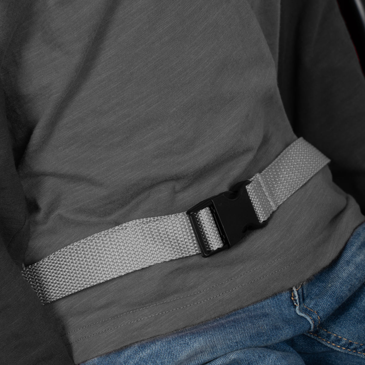Close up of the gray seat belt on a child's lap