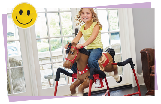 Child riding a toy spring horse in a room.