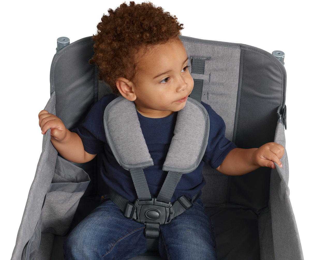 Child sitting in wagon wearing a 5-point harness with shoulder pads