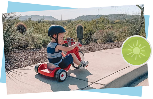 Child riding a chopper trike outdoors.