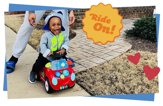 Child riding on a toy car on a sidewalk, with 'Ride On!' text overlay.
